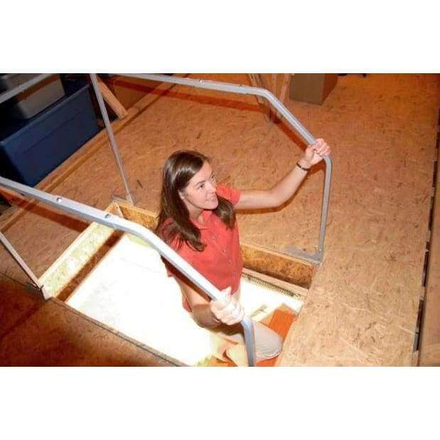 Versa Rail model 60 attic ladder safety rail VRM60 with woman holding handrail while going up the ladder into the attic..